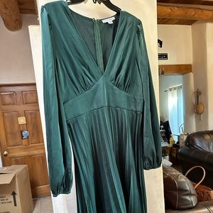 Size XL emerald green midi length dress. Satin material with pleats.